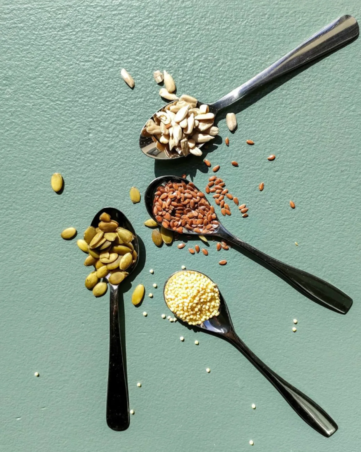 nuts and seeds on spoons